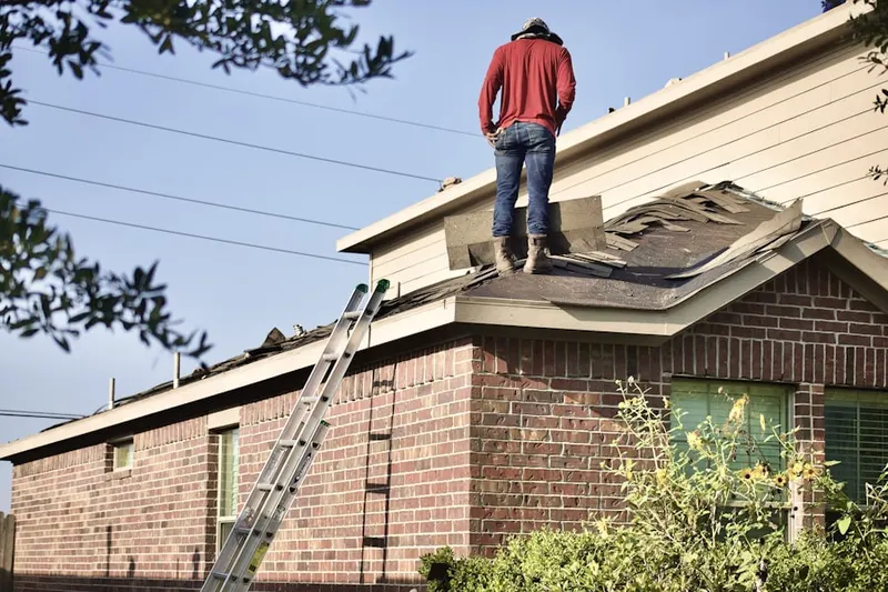 Professional roofer working on a residential roof in Notre Dame